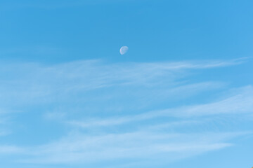 Naklejka na ściany i meble Bright blue sky with moon and clouds, sky and moon background