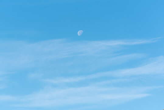 Bright blue sky with moon and clouds, sky and moon background