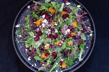 Overhead view of delicious hearty bowl of beets and arugula salad makes the mouth water and the stomach growl.