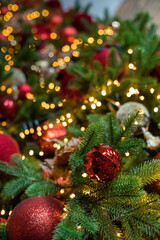 Obraz na płótnie Canvas Decorated Christmas tree closeup. New Year baubles macro photo. Winter holiday light decoration