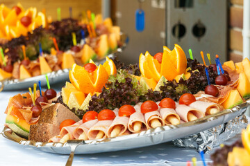 Summer buffet with orange, tomatoes, ham and asparagus