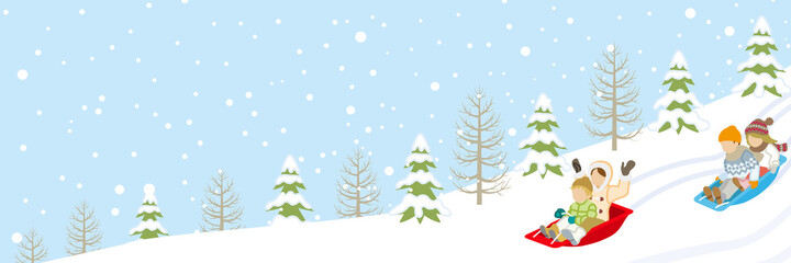 Children sledding in the winter snowcoverd slope