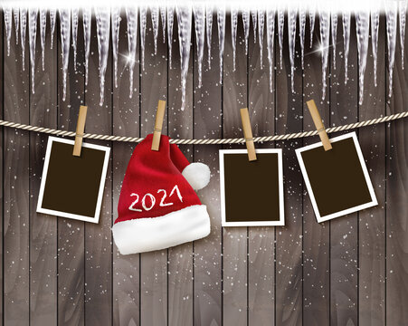 Merry Christmas and New Year Holiday background with photos and a santa hat with 2021 on the rope. Vector.