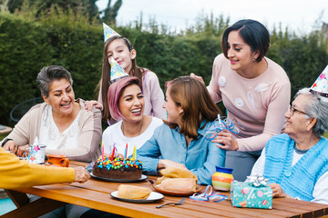 hispanic Family happy birthday celebration garden party outside in the backyard in Mexico City