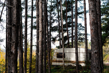 Abandoned caravan RV motorhome in the woods symmetry contrast sharp details and vivid colors in Bulgaria, Eastern Europe