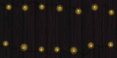 Dark wooden planks illuminated by retro Christmas electric garland