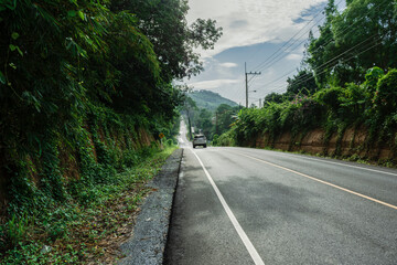 Beautiful green road in countryside, Landscape road with green forest, Main road on the mountain