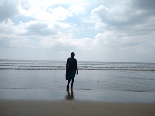 A young woman looking towards the sea