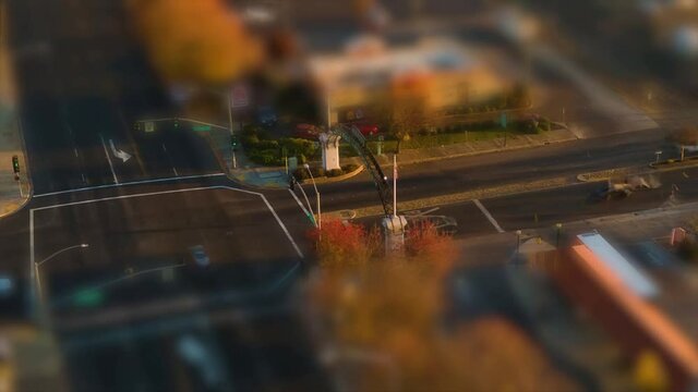 Small town intersection hyper lapse at sunset with miniature tilt shift effect