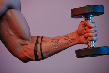A close photo of a muscular arm which is doing bicep curls with a dumbbell under blue and red...