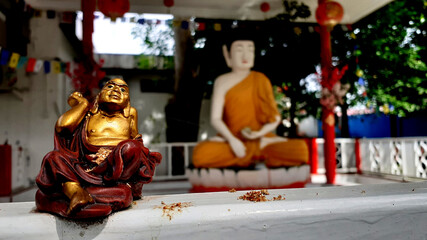 Buddhist statue ornament with a Buddha statue background.