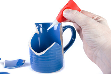 Dip of glue ready to drop onto a piece of glass being repaired