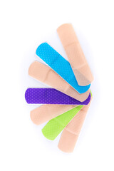 Multicolored array of sticky bandage strips in an arc