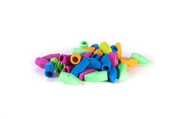 Pile of multicolored rubber pencil topper erasers pastel colors side view