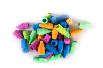 Pile of multicolored rubber pencil topper erasers pastel colors top down view