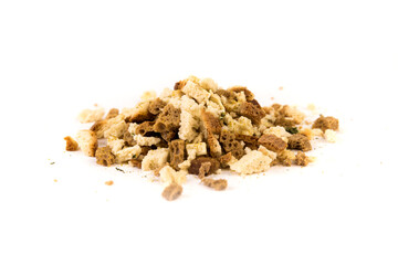 Cup of uncooked bread stuffing and spices isolated over white