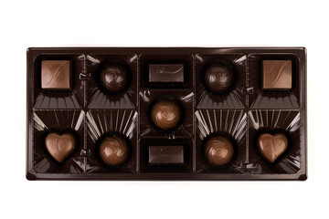 Top down view of small box of milk and dark chocolates in a shiny brown display