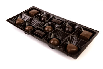 Select box of milk and dark chocolates in a shiny brown display