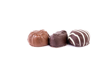 Three delicious chocolates in a row isolated over white