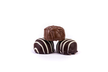 Light and dark striped chocolates stacked in a pyramid isolated over white