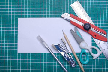 Empty white paper with stationary on cutting mat