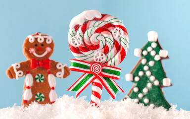 Christmas Lollipop, Christmas tree, ginger man in the snow on a blue background. Happy New year. Christmas background. 