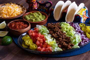 Close up of a platter filled with toppings for making tacos.