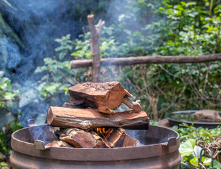 A wood fire to prepare coals for a traditional South African outdoor braai barbecue