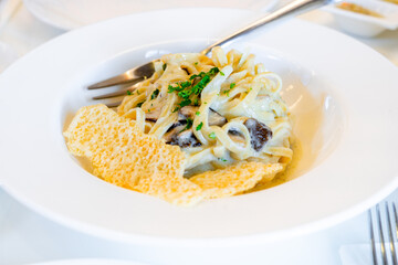 Truffle mushroom pasta nicely served on white plate