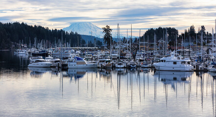 Fototapeta na wymiar Marina in Gig Harbor with boats in the harbor with dramatic clouds and mt rainier 