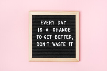 Every day is a chance to get better, don't waste it. Motivational quote on black letter board on pink background. Concept inspirational quote of the day. Greeting card, postcard