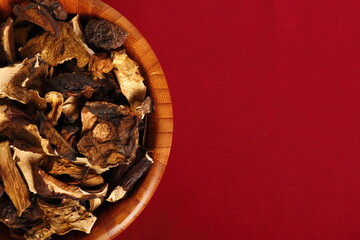 Dried mushrooms in wooden bowl. Boletus badius.