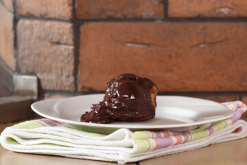 Choux pastry ball with custard filling and chocolate sauce icing