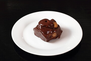 Choux pastry ball with custard filling and chocolate sauce icing
