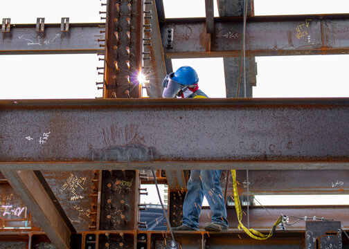 site worker welding steel structure for a skycraper