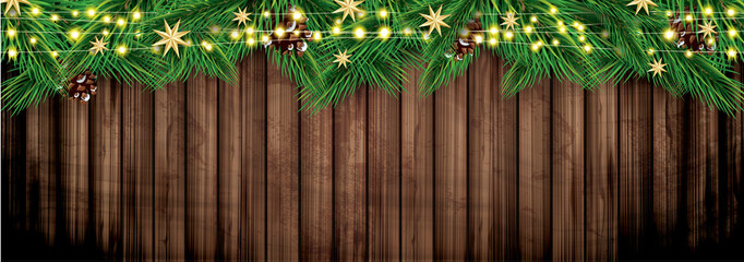 Fir Branches with Neon Lights on Wooden Background. Christmas Decoration with Golden Stars.