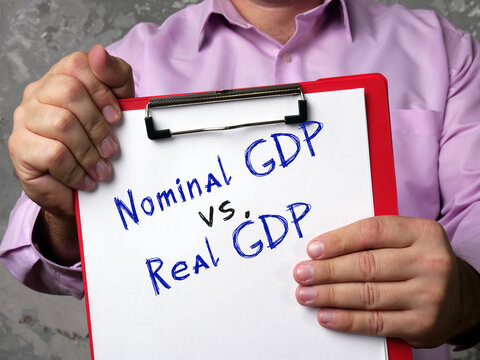Business concept about Nominal GDP vs. Real GDP gross domestic product with sign on the sheet.