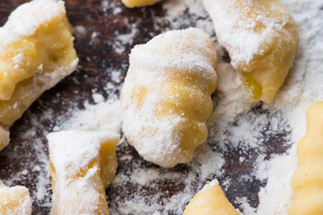 Uncooked homemade potato gnocchi with fork