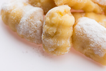 A pile of gnocchi on a white background