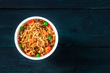Ramen cup. Instant noodles in a plastic cup, shot from the top with copy space