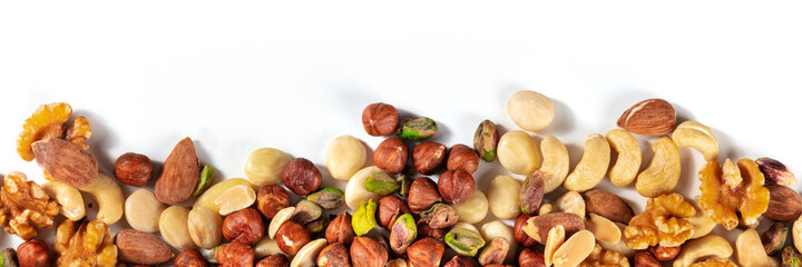 Nuts panorama with a place for text. A mix of peanuts, hazelnuts, walnuts, pistachios, cashews and almonds, shot from the top