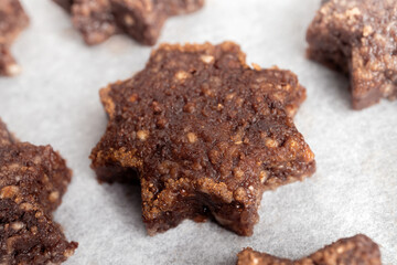Gluten free almond flour and chocolate cookie in shape of a star with sugar cinnamon rim, ready to be baked. Swiss recipe 