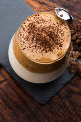 Dalgona coffee in glass cup. Korean trendy drink from instant coffee, milk and brown sugar