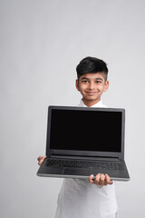 Cute indian little boy showing laptop screen