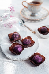 Handmade chocolate truffle on a festive white table. Dorblu sweets