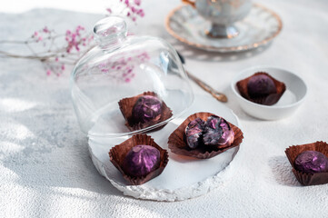 Handmade chocolate truffle on a festive white table. Dorblu sweets
