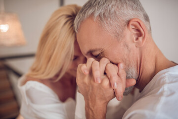 Man holding his woman hand and looking romantic