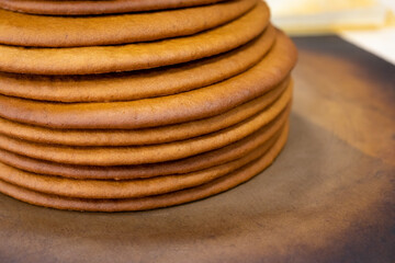 Cooking honey cake at home. Many round baked cakes on top of each other, blanks without cream.
