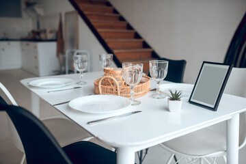 Picture of a table in the kitchen with a plate and glasses on it