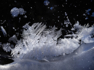 Stunning frozen icicles waterfall on a rocky mountain cliff on a winter day. The winter cascade is frozen in numerous white icicles. Waterfall falling past hundreds of icicles fantastic winter landsca